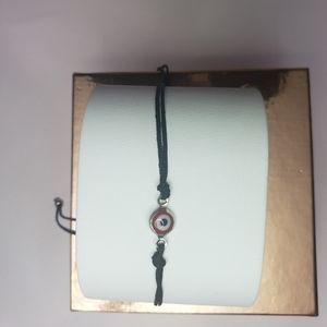 Black bracelet with red eye and blue eye